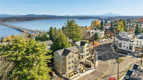 an outdoor space with wooden floor and lake view