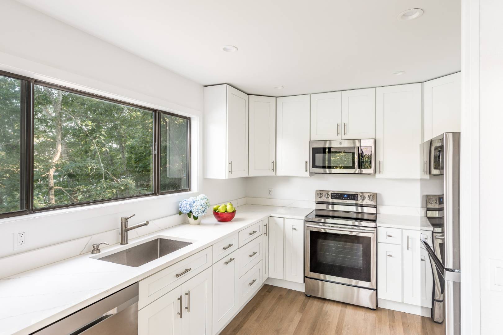 99 Isle Of Wight Road East Hampton, NY 11937 - Photo 11 of 24 a kitchen with stainless steel appliances a stove sink and microwave