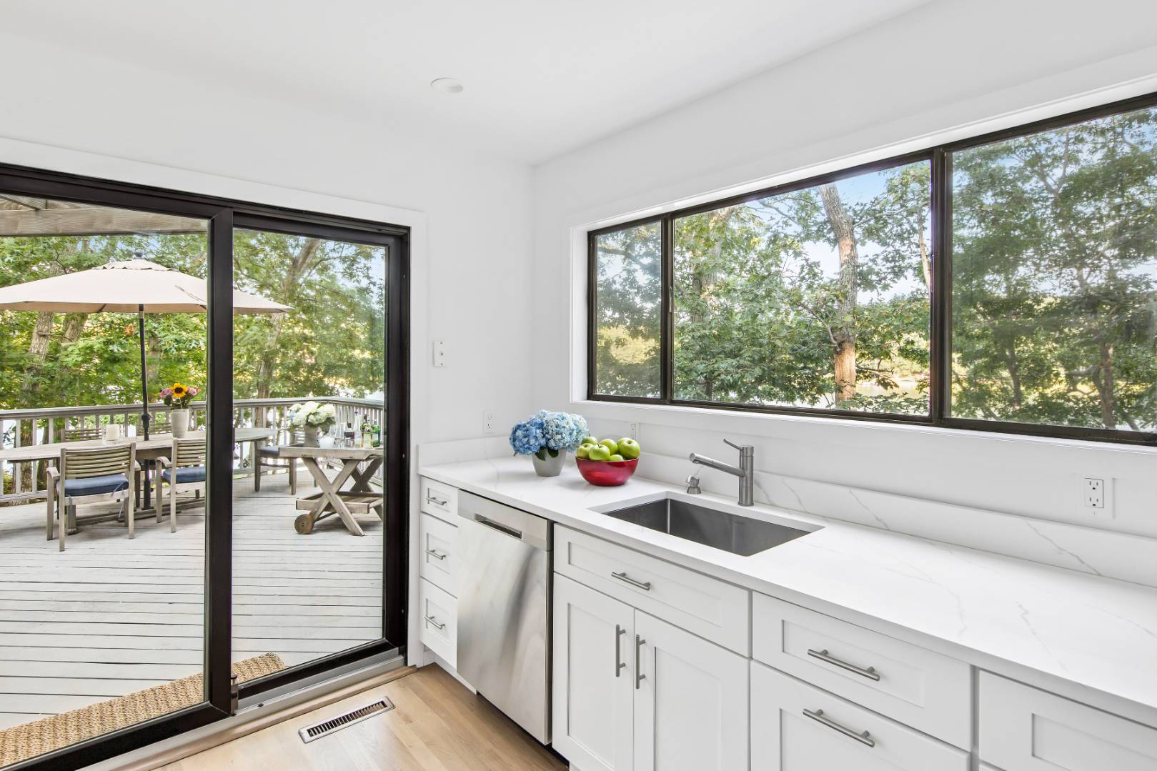 99 Isle Of Wight Road East Hampton, NY 11937 - Photo 12 of 24 a kitchen with stainless steel appliances a sink and cabinets