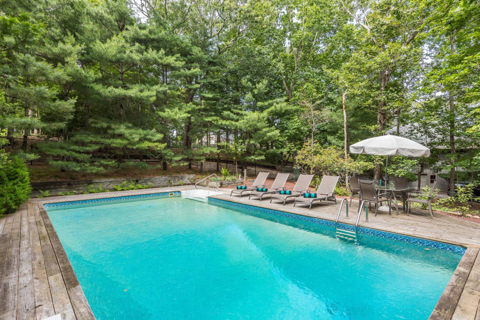 99 Isle Of Wight Road East Hampton, NY 11937 - Photo 19 of 24 a view of a swimming pool and lounge chairs