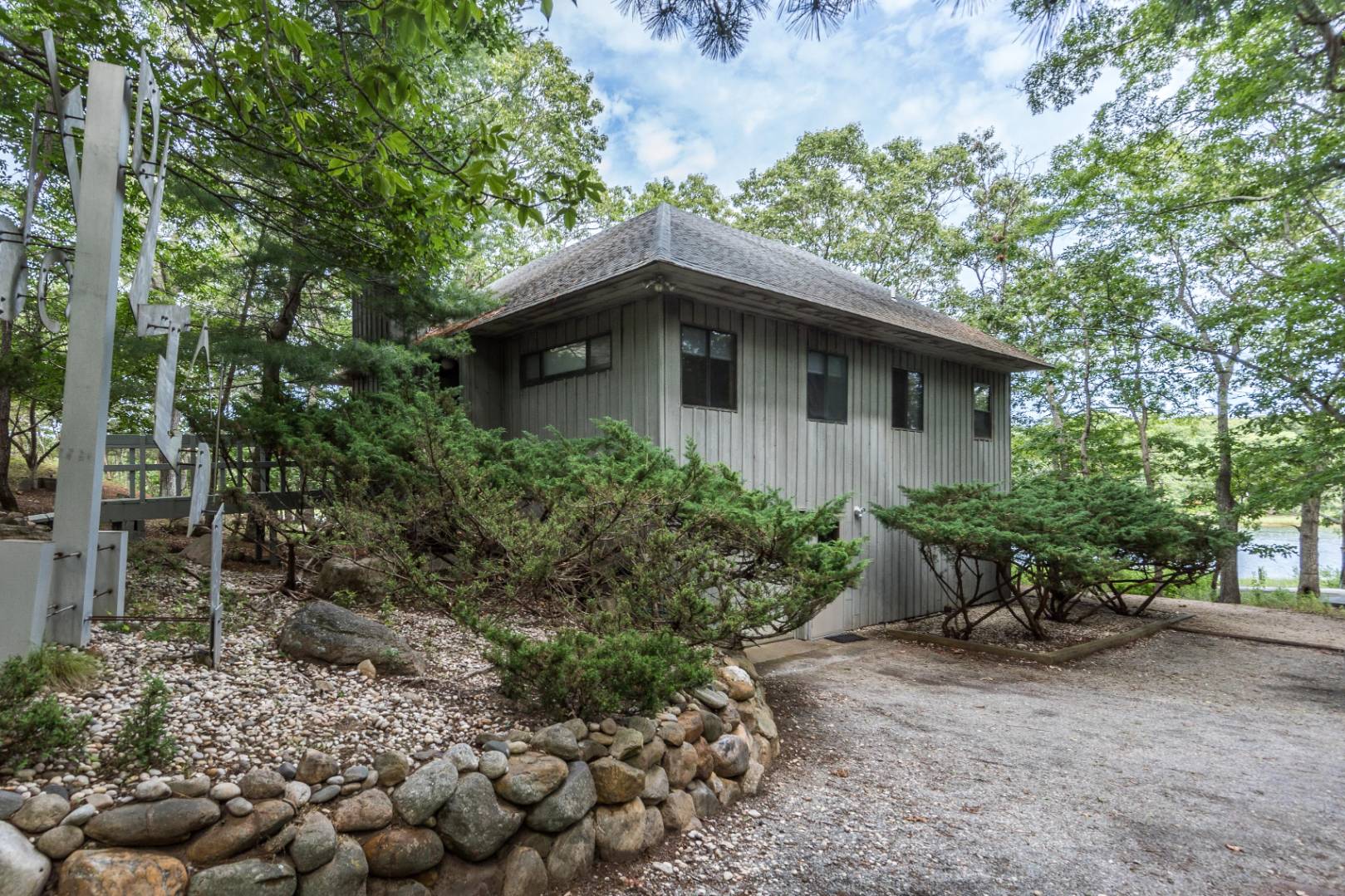 99 Isle Of Wight Road East Hampton, NY 11937 - Photo 3 of 24 a yellow house with a outdoor space