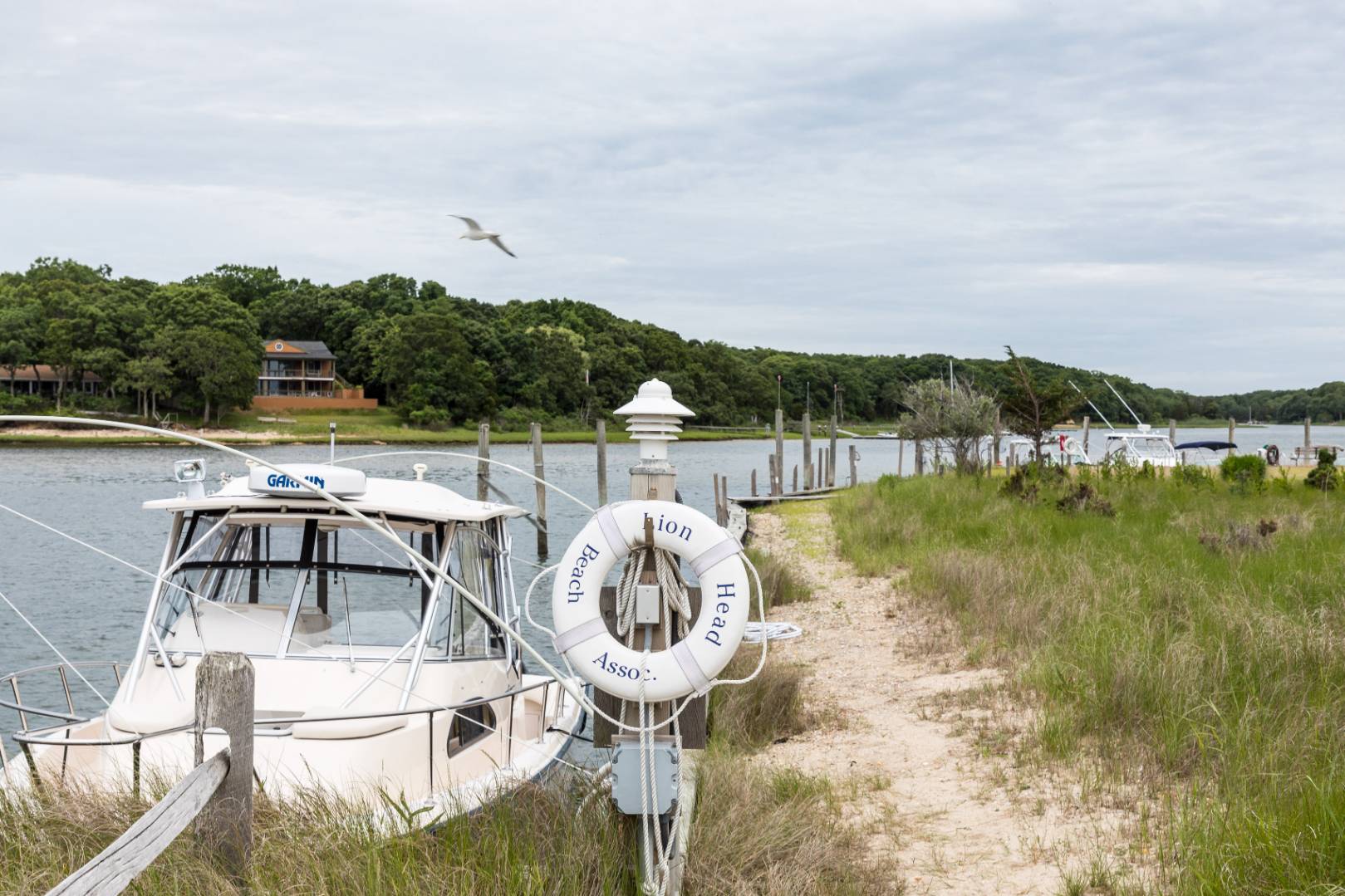 99 Isle Of Wight Road East Hampton, NY 11937 - Photo 23 of 24 a view of a lake with couches and city view