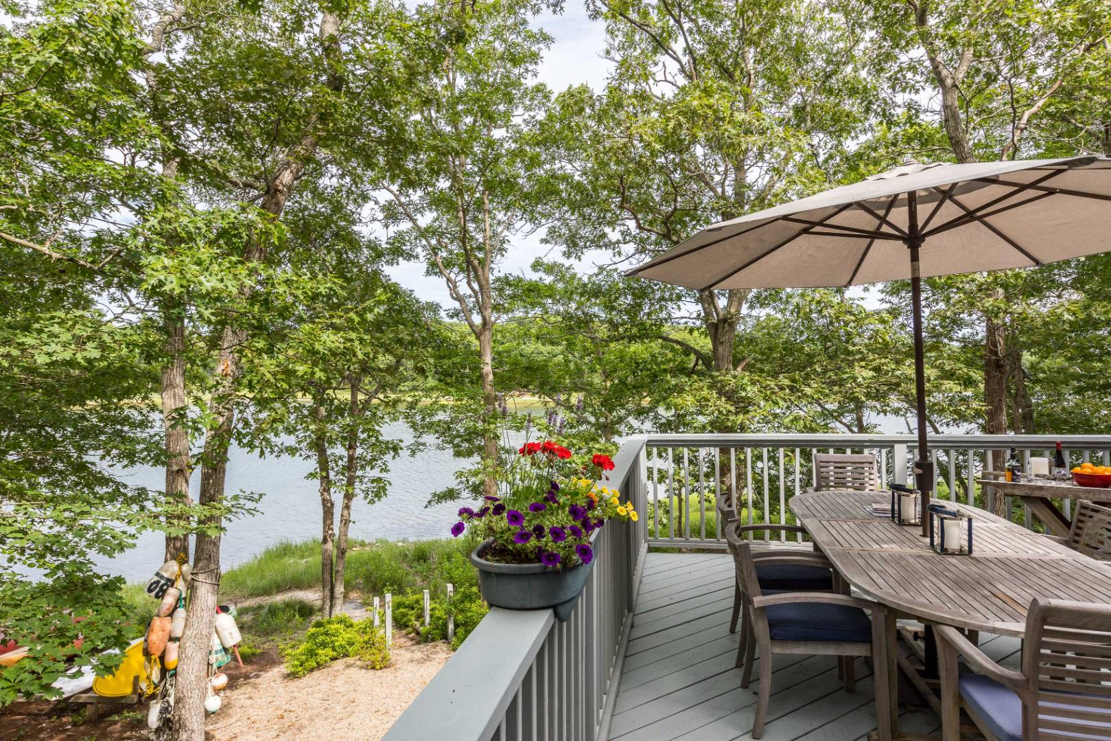 99 Isle Of Wight Road East Hampton, NY 11937 - Photo 7 of 24 a view of a chairs and table under an umbrella