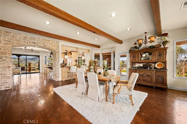 a view of a dining room with furniture wooden floor and chandelier