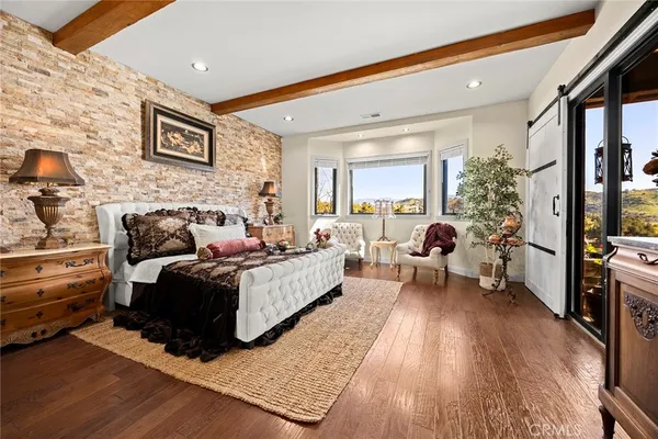 a view of a patio with table and chairs potted plants and palm tree