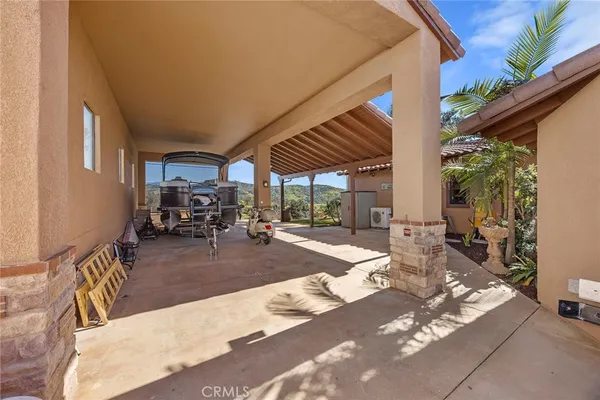 a living room with furniture a fireplace and a large window