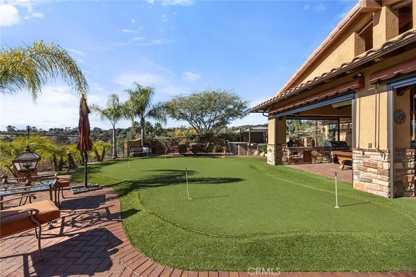 a view of a house with fountain in front of a house