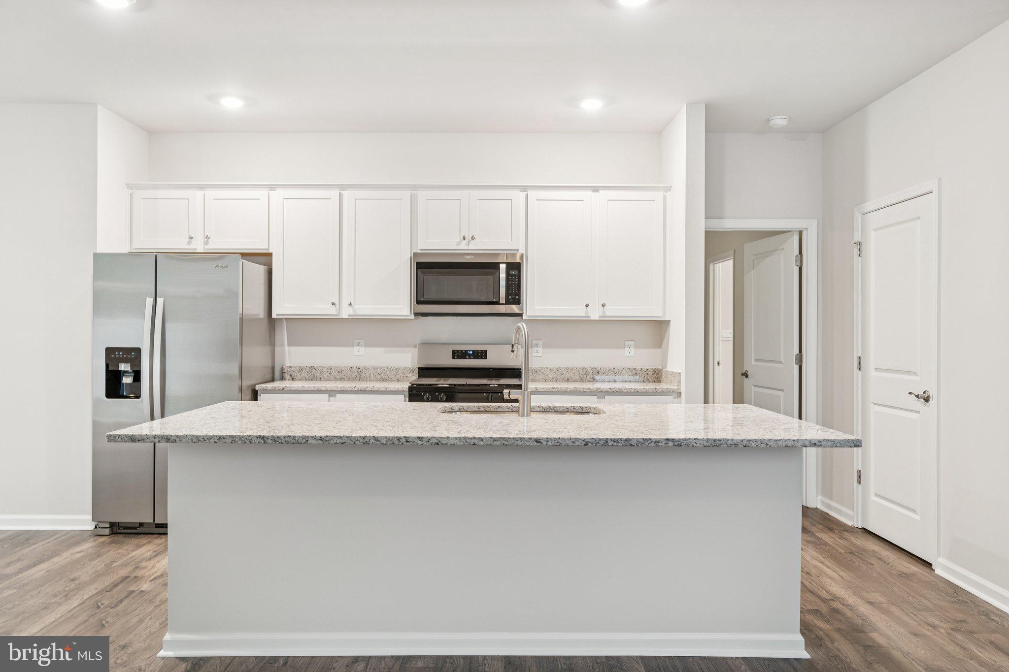 6306 Sterling Way Ruther Glen, VA 22546 - Photo 2 of 32 a kitchen with stainless steel appliances a refrigerator sink stove microwave and cabinets