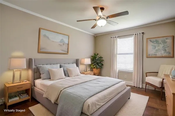 a bedroom with a large bed and a chandelier