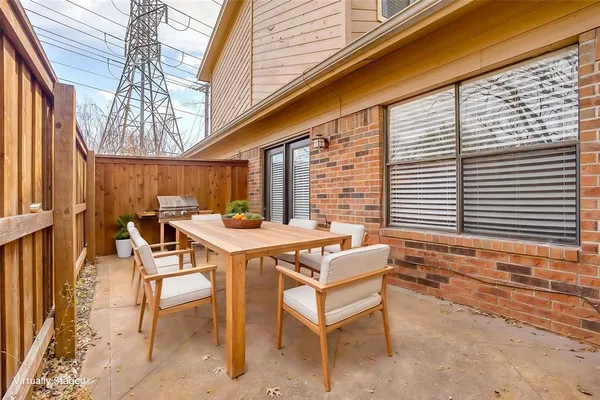a patio with a table and chairs
