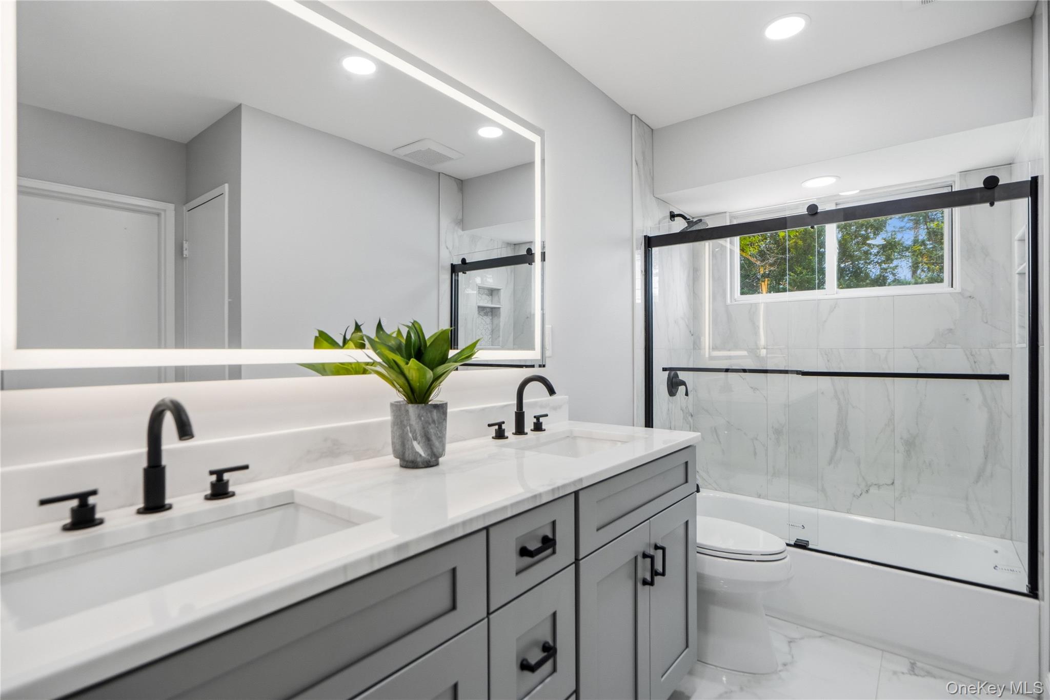 183 North Marginal Road Jericho, NY 11753 - Photo 17 of 28 Modern bathroom featuring a double vanity with gray cabinetry and white quartz countertops