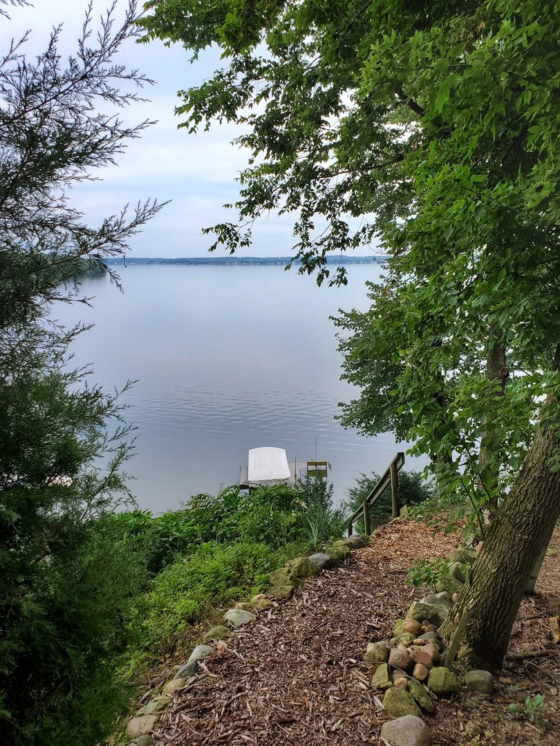 155 Cora Avenue Fox Lake, IL 60020 - Photo 1 of 1 a backyard of a house with lots of green space and lake view