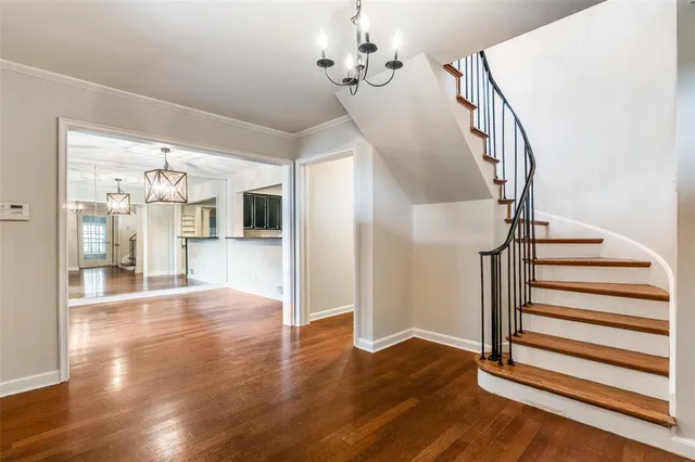 a view of a livingroom with wooden floor and stairs