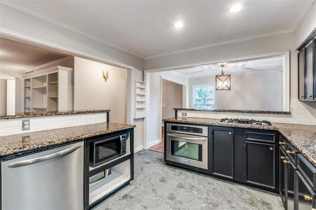 a kitchen with stainless steel appliances granite countertop a stove and a sink