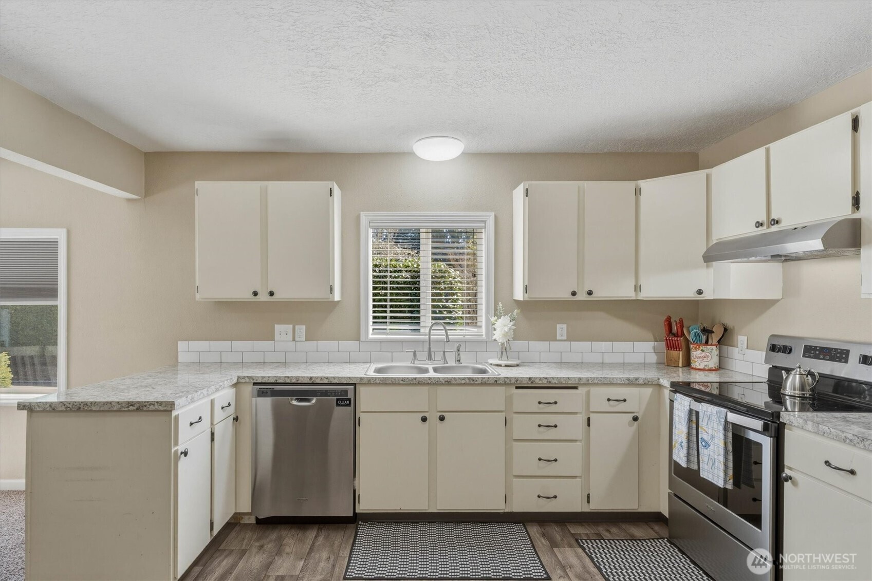 3805 Pacific Way Longview, WA 98632 - Photo 11 of 37 a kitchen with cabinets appliances a sink and a window