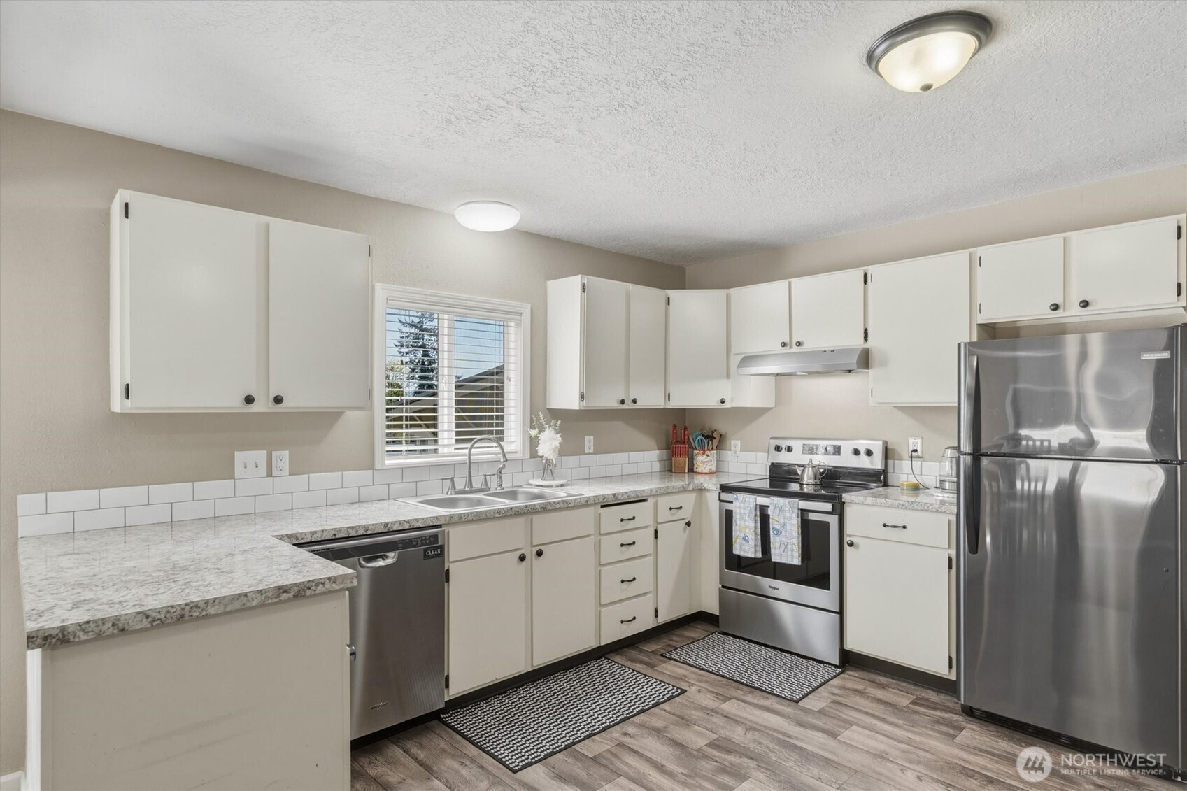 3805 Pacific Way Longview, WA 98632 - Photo 12 of 37 a kitchen with stainless steel appliances granite countertop a stove a sink dishwasher and a refrigerator