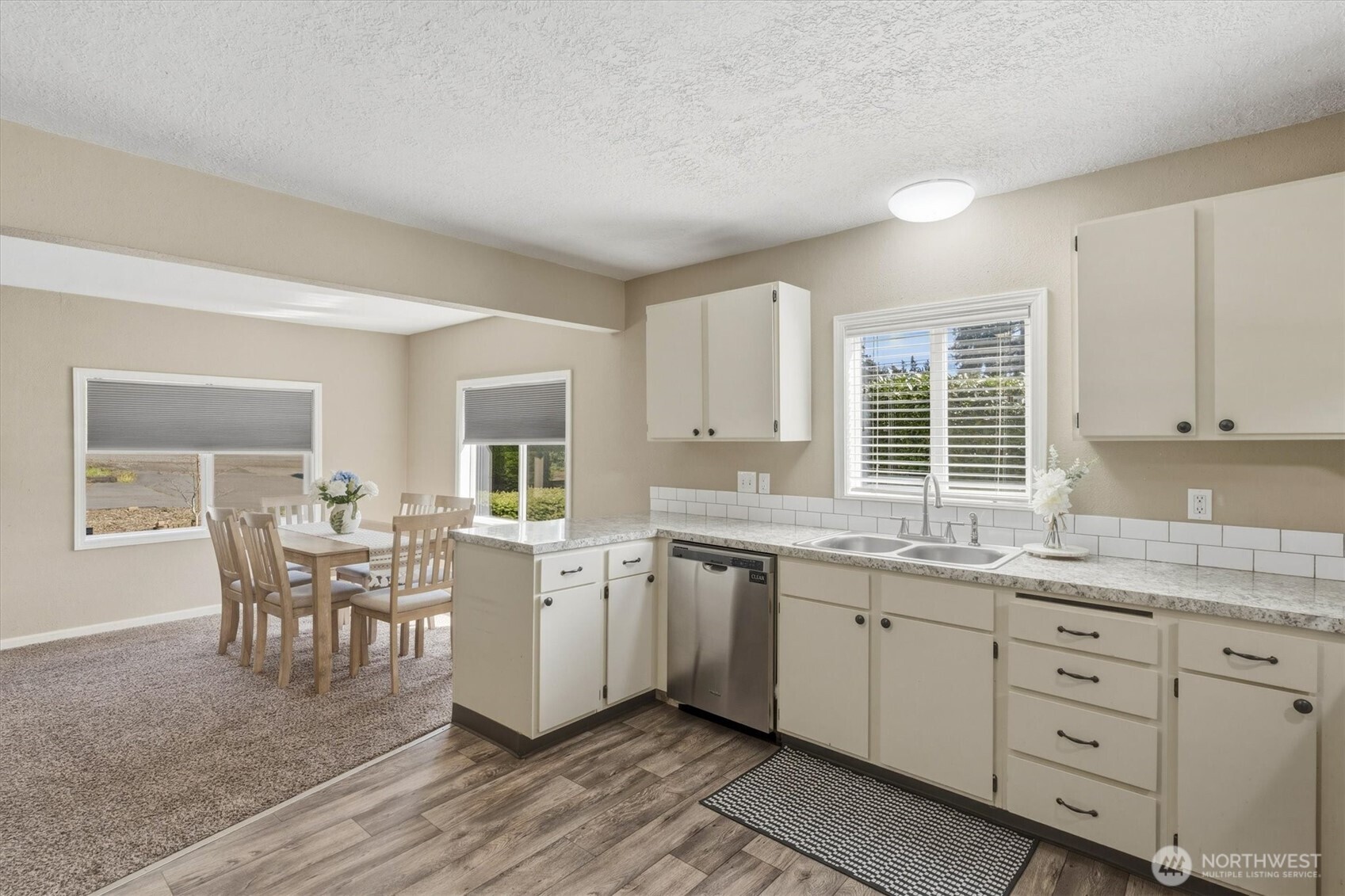 3805 Pacific Way Longview, WA 98632 - Photo 13 of 37 a kitchen with a dining table chairs and white cabinets