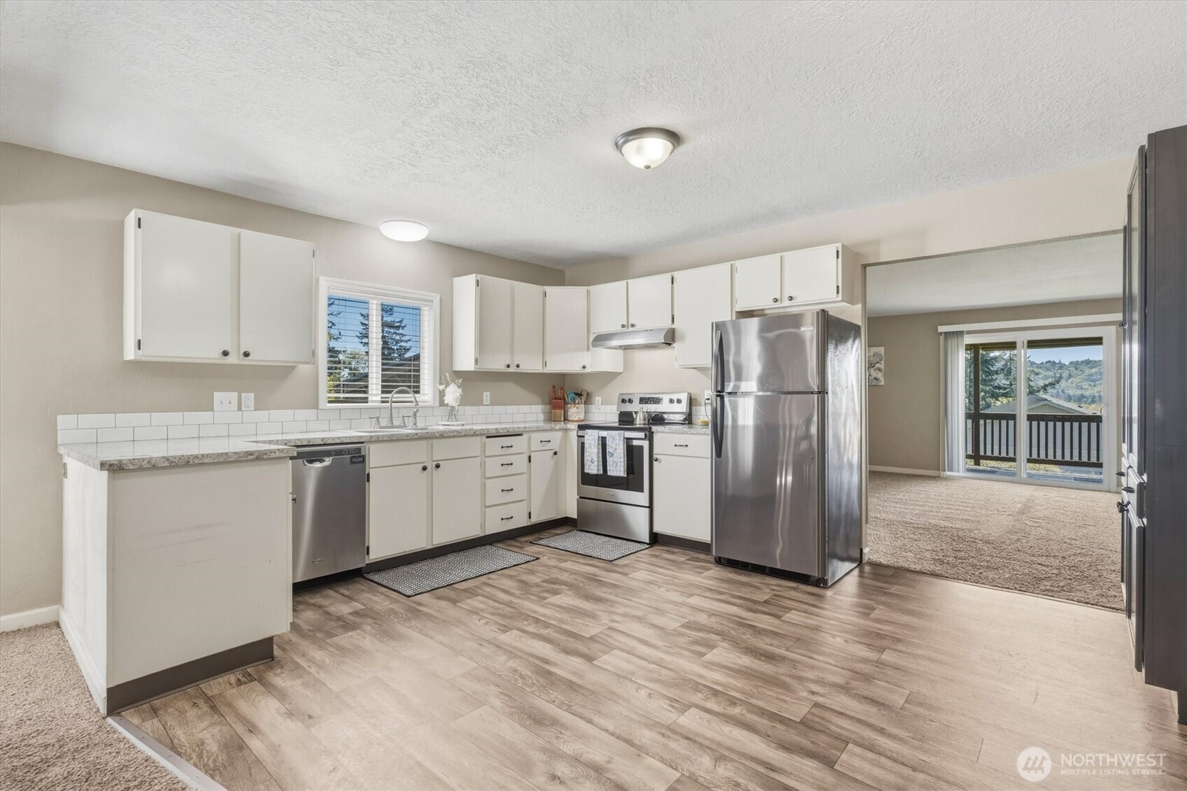 3805 Pacific Way Longview, WA 98632 - Photo 10 of 37 a kitchen with a refrigerator a sink and cabinets