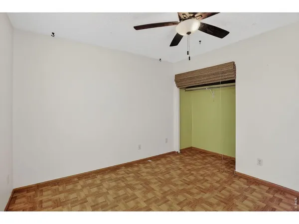 a view of an empty room with a ceiling fan