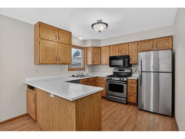 a kitchen with a refrigerator sink and microwave