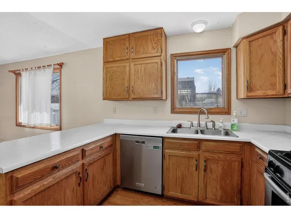 a kitchen with a sink cabinets and wooden floor