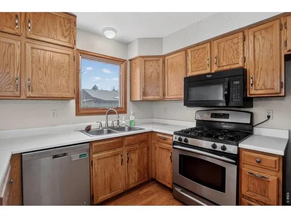 a kitchen with stainless steel appliances a stove sink microwave and cabinets