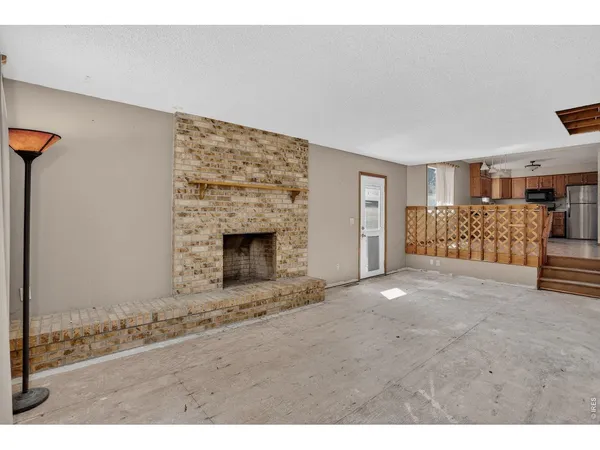 a view of an empty room with a fireplace