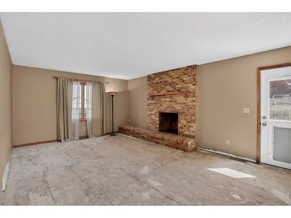 a view of empty room with fireplace