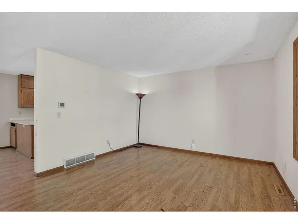 a view of an empty room and wooden floor