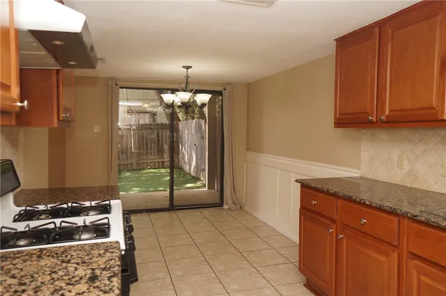 a kitchen with a sink stove and cabinets