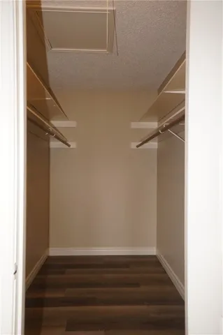 a view of storage and utility room with wooden floor