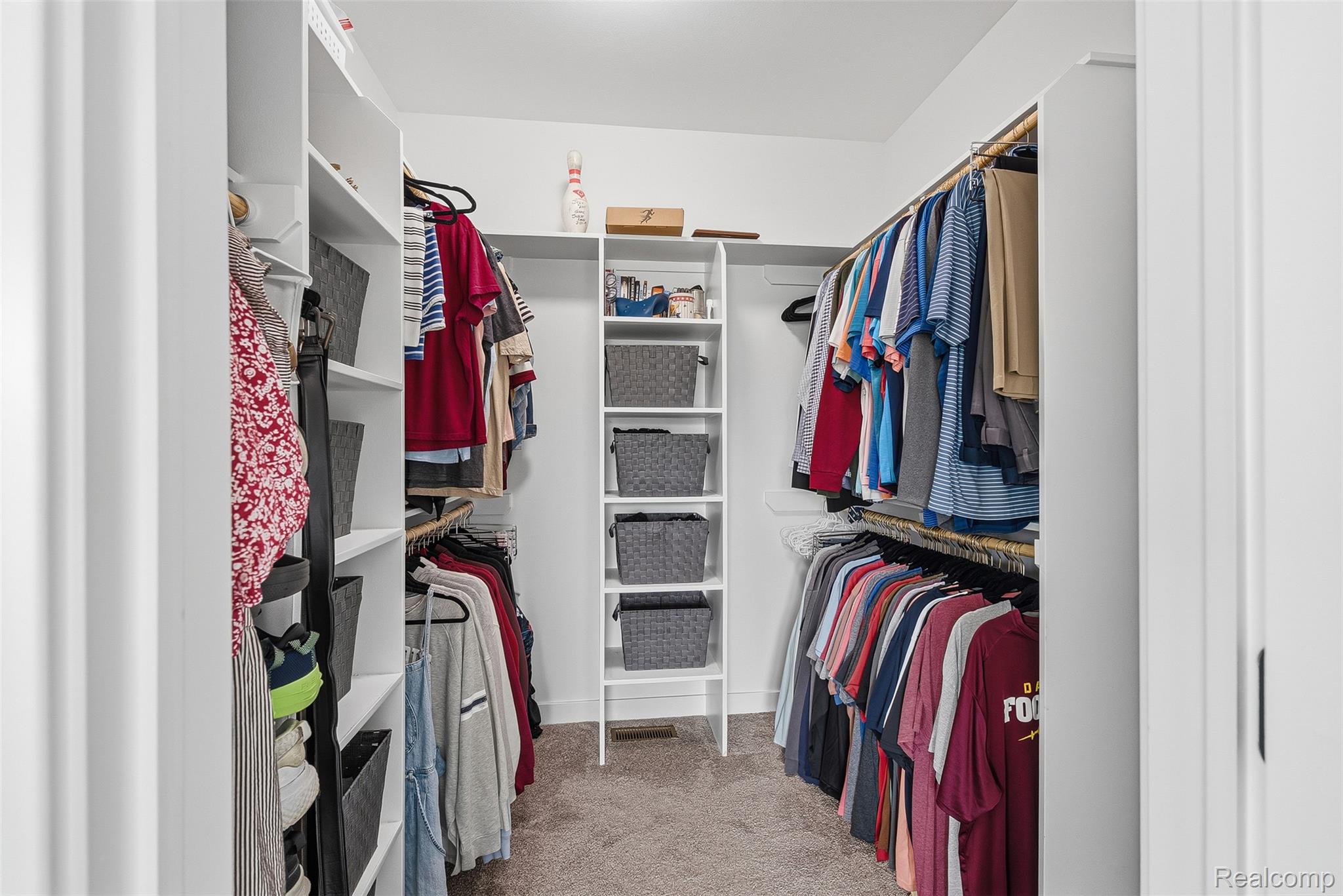 9087 Copper Ridge Drive Davison, MI 48423 - Photo 32 of 46 Walk-in closet featuring white built-in shelving, multiple hanging rods, and carpet flooring