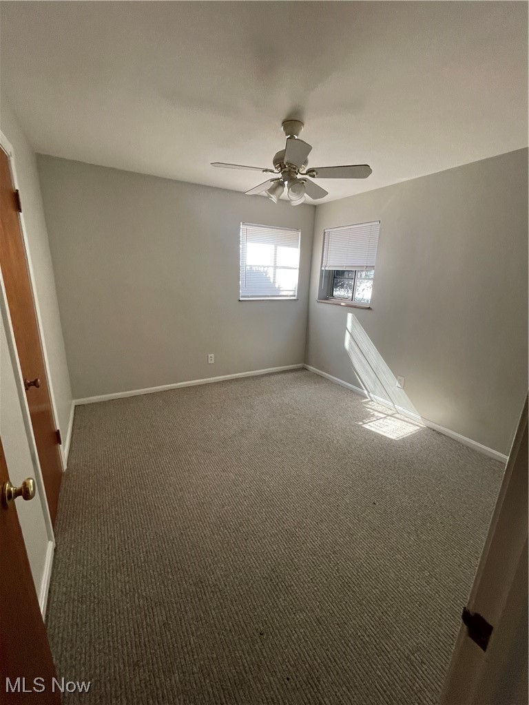 19860 Lorain Road, Unit 1 Cleveland, OH 44126 - Photo 4 of 8 Carpeted spare room with baseboards and ceiling fan
