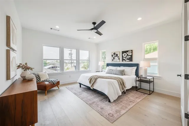 a spacious bedroom with a bed couch and a large window