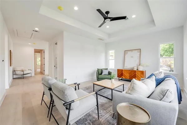 a living room with furniture and a wooden floor