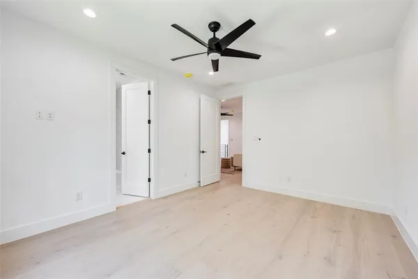 an empty room with closet and ceiling fan