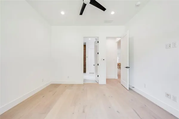 an empty room with ceiling fan and window