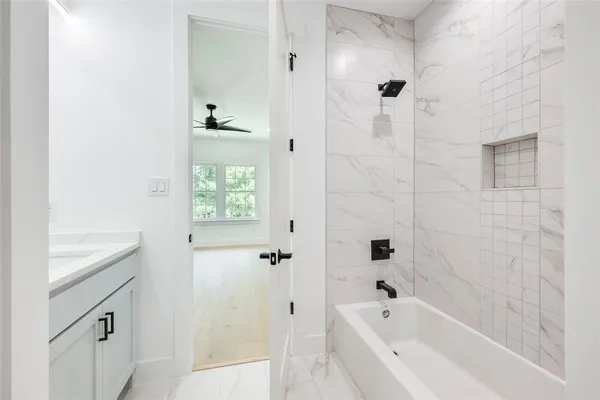 a bathroom with a bathtub and shower