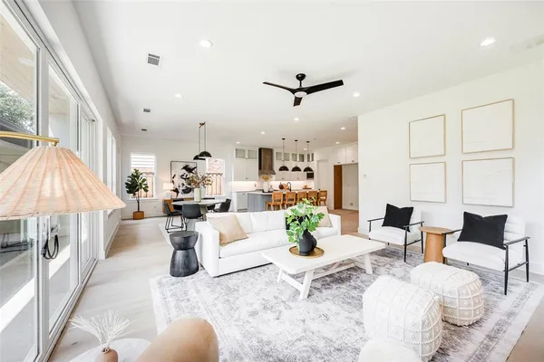 a living room with furniture and a chandelier