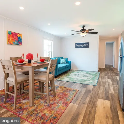 a view of a dining room with furniture and chandelier