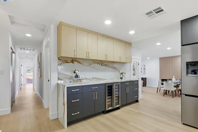 a kitchen with stainless steel appliances granite countertop a lot of counter space and wooden floors