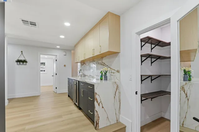 a view of kitchen with hallway and wooden floor