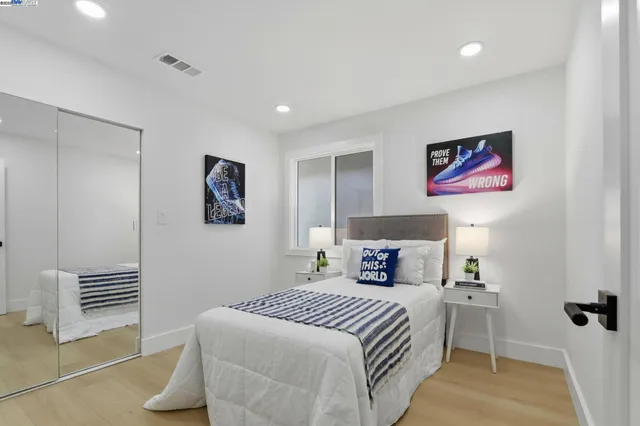 a bedroom with a bed and a lamp