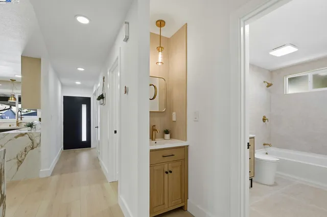a bathroom with a sink a toilet and mirror