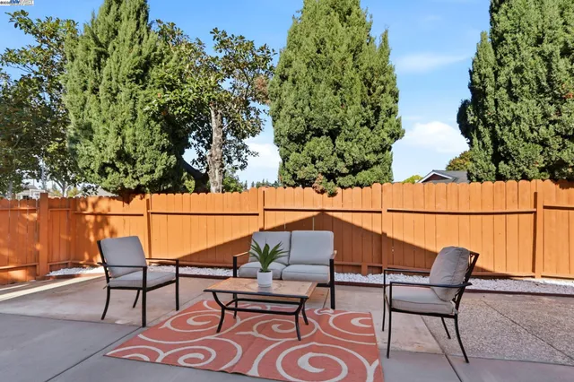 a view of a house with backyard and sitting area