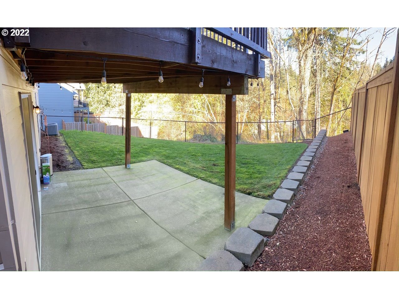 6873 Southwest Locust Street Tigard, OR 97223 - Photo 6 of 6 a backyard of a house with table and chairs