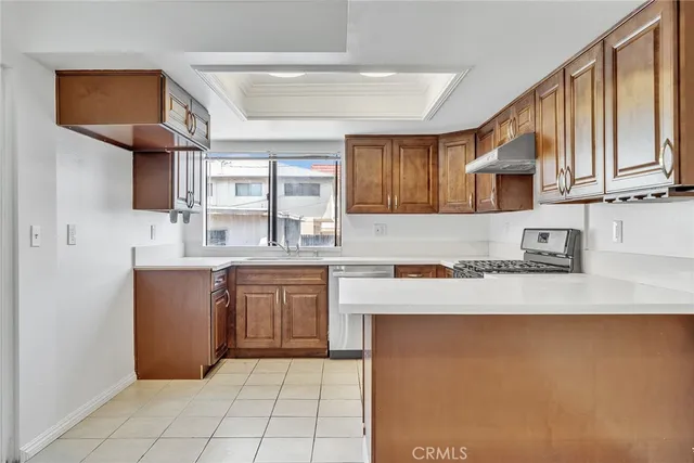 a kitchen with stainless steel appliances granite countertop a refrigerator sink and cabinets