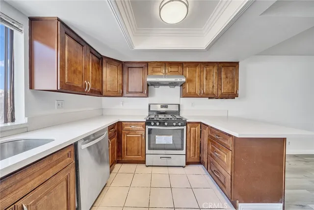 a kitchen with a stove top oven sink and cabinets