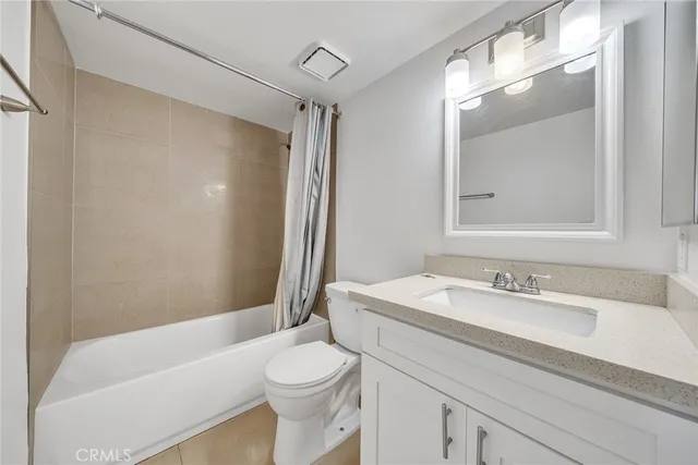 a bathroom with a sink a toilet tub and shower