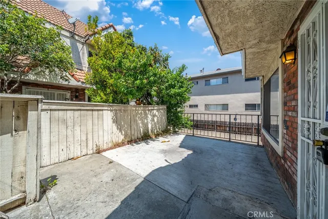a view of backyard with small cabin and wooden fence